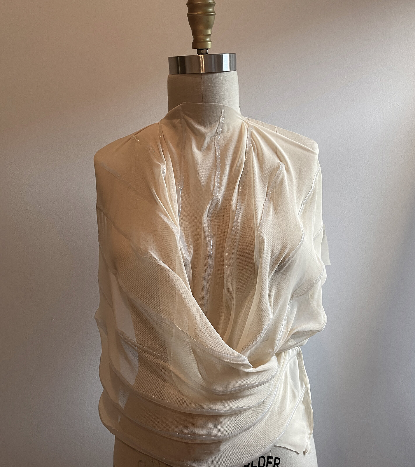 Draped cowl garment on dress form